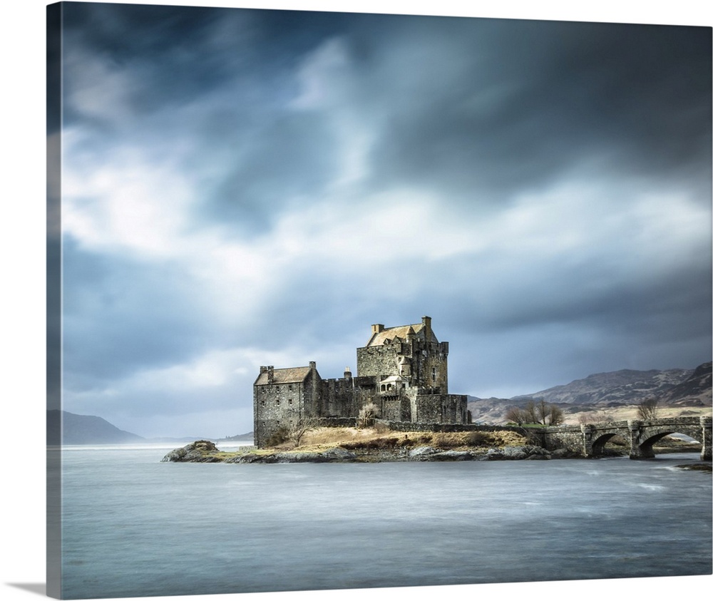Beautiful Scottish Castle in the Scottish Highlands called Eilean Donan with a teal sky and drifting clouds.