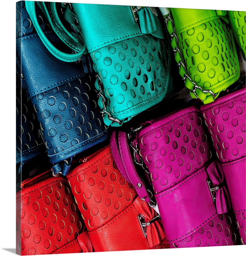 An assortment of brightly colored leather purses for sale.