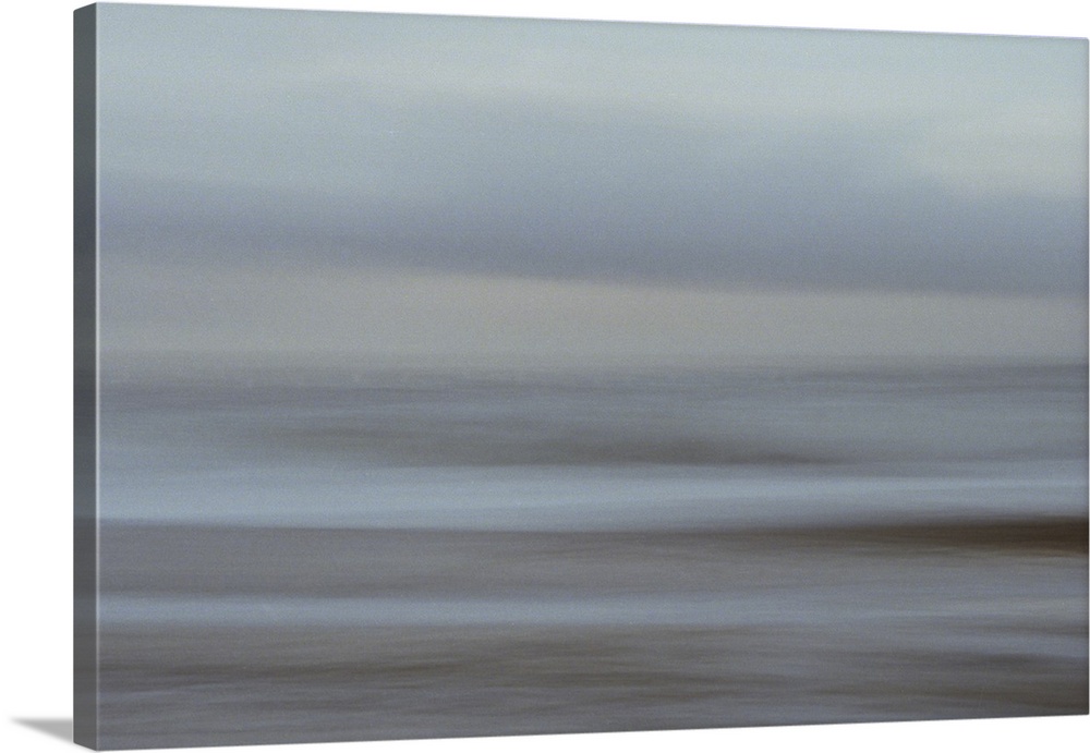 Artistically blurred photo. Early in the evening on a winter day. The cloudy sky embraces the sea.