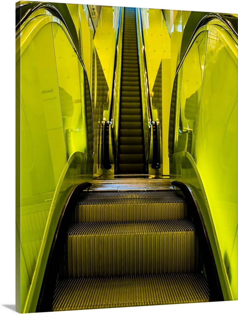Abstract view of escalator steps with lime green paneling.