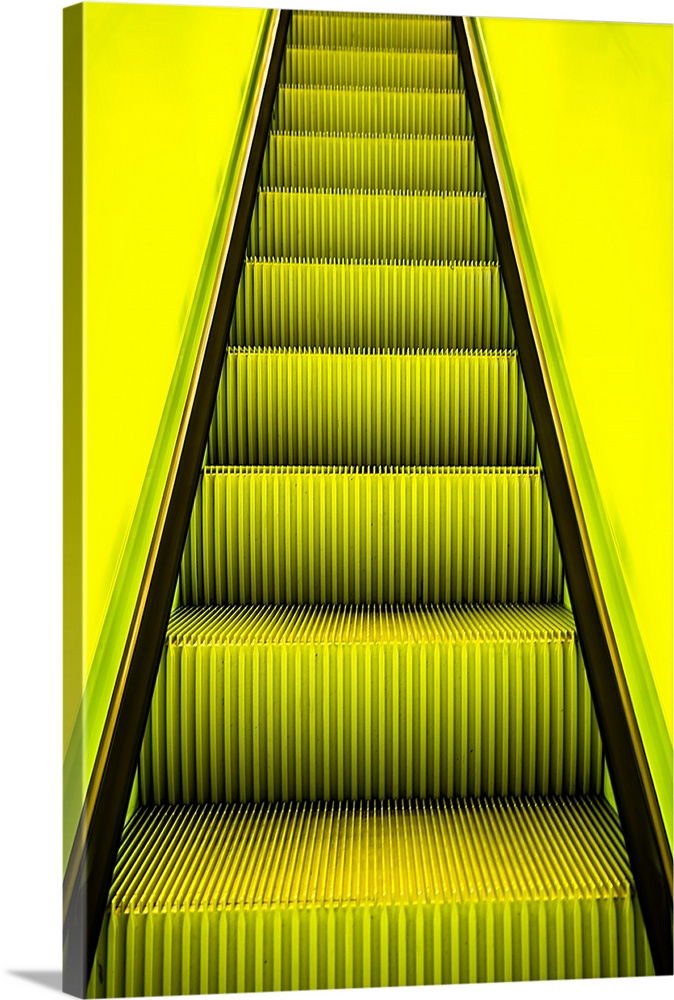 Bright yellow light on escalator steps leading upwards.