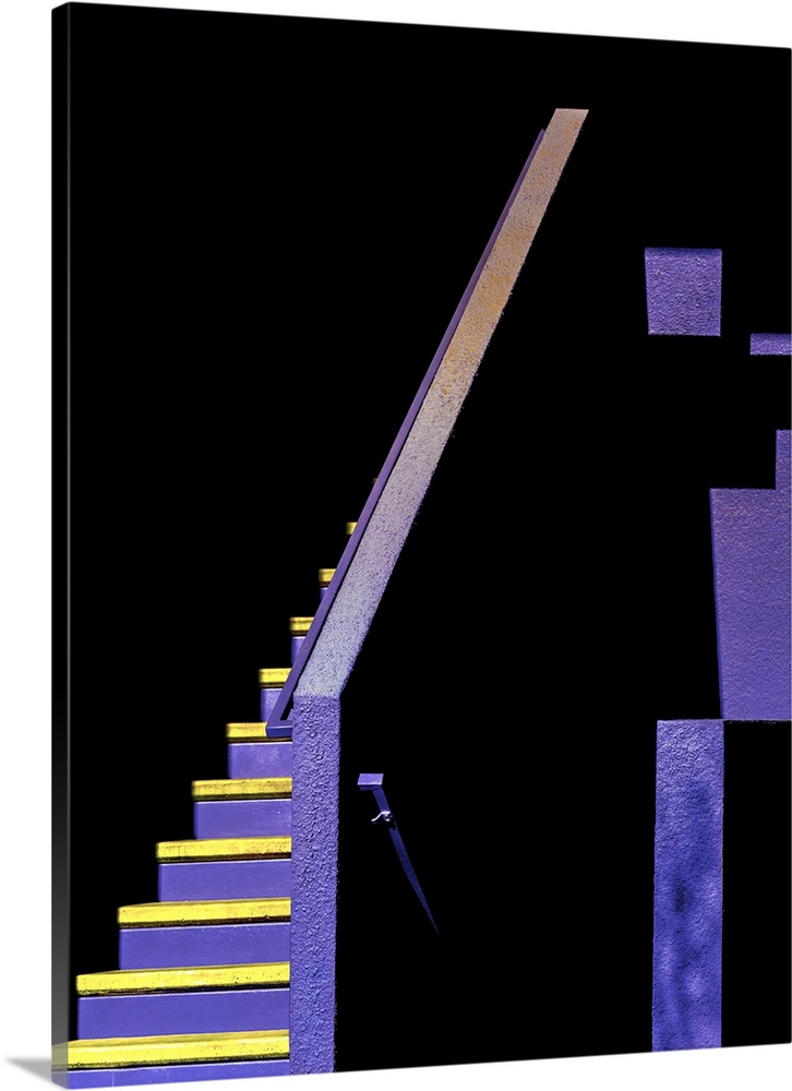 Interesting yellow and purple painted staircase leading into the shadows.