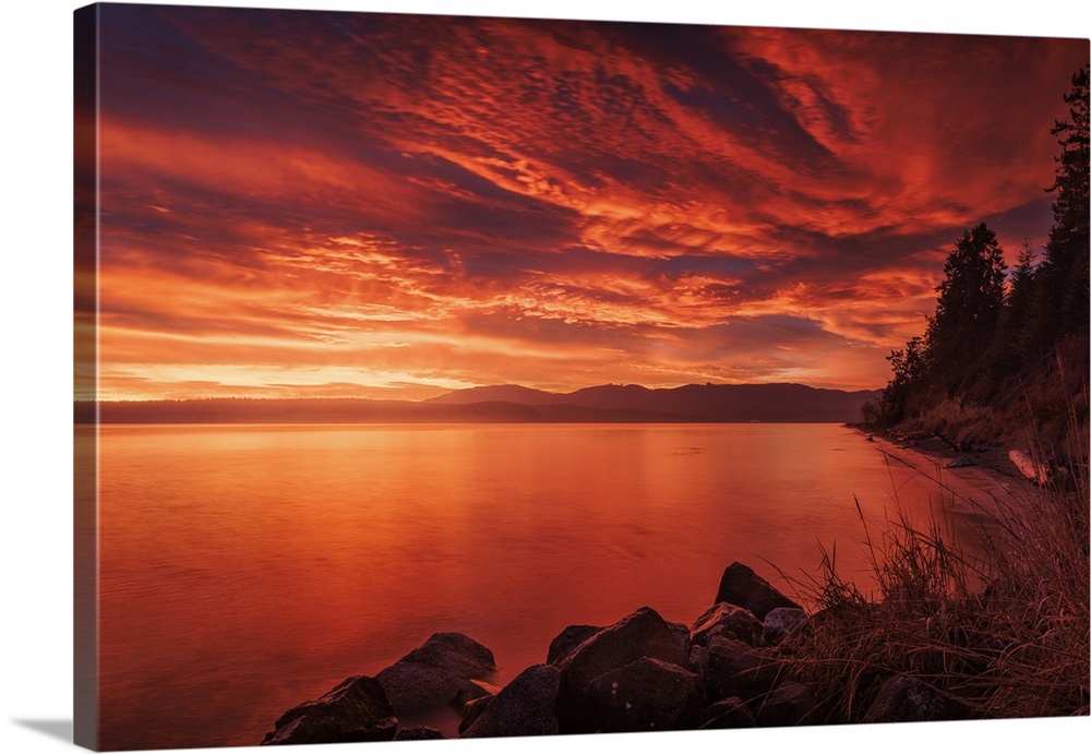 A stunning fiery sky before sunrise at Port Williams Beach in Washington State.