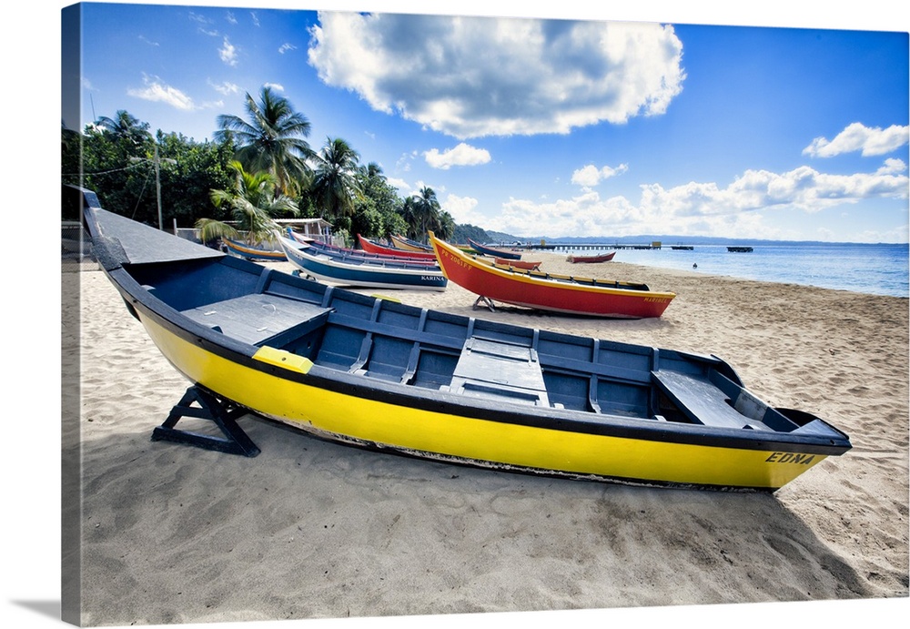 Low angle view of colorful, small wooden, fishing boats on a Caribbean beach, Crash Boat Beach, Aguadilla, Puerto Rico.