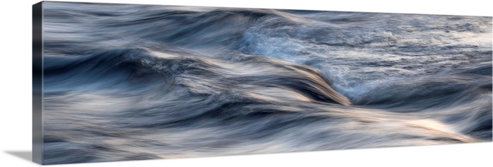 Photograph of blurred motion waves of water rustling.