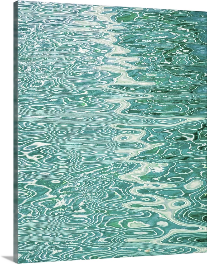 Abstract pattern created by rippling water reflecting lines in a pool.