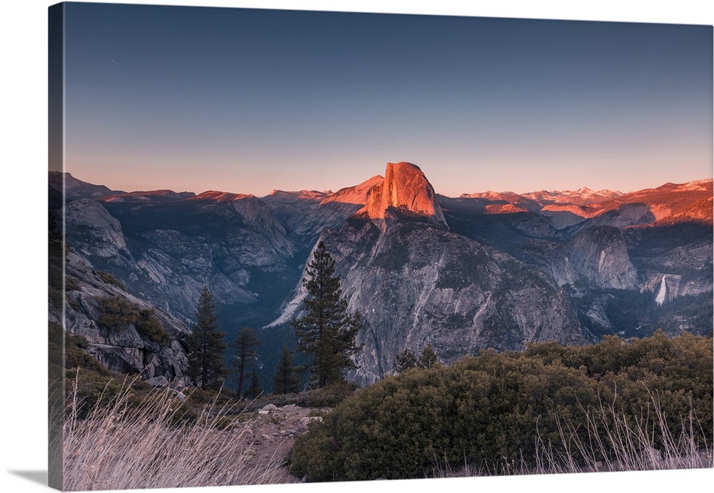Half Dome in golden color during sunset at Glacier Point, Yosemite National Park, California.