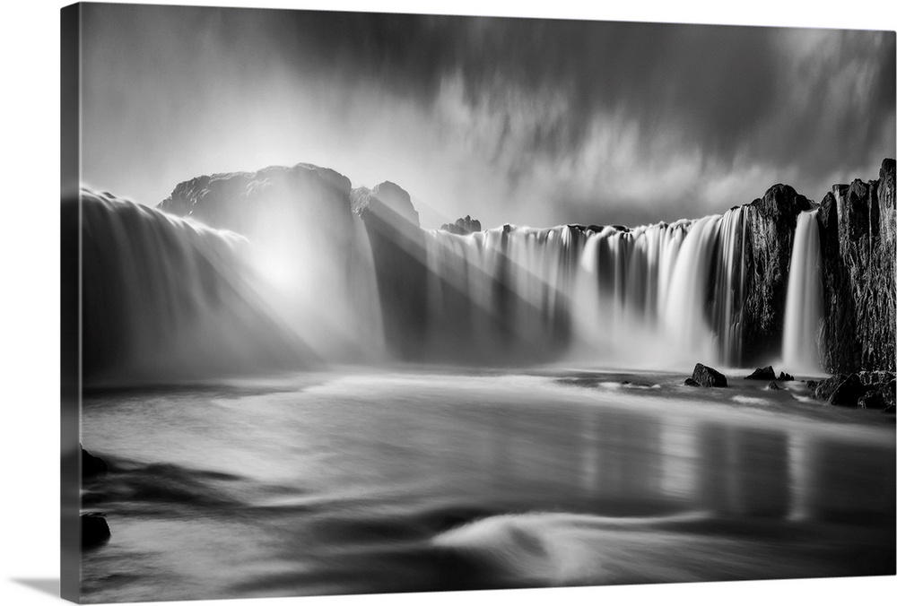 Fine art photograph of sunlight shining over the waterfalls in Iceland.