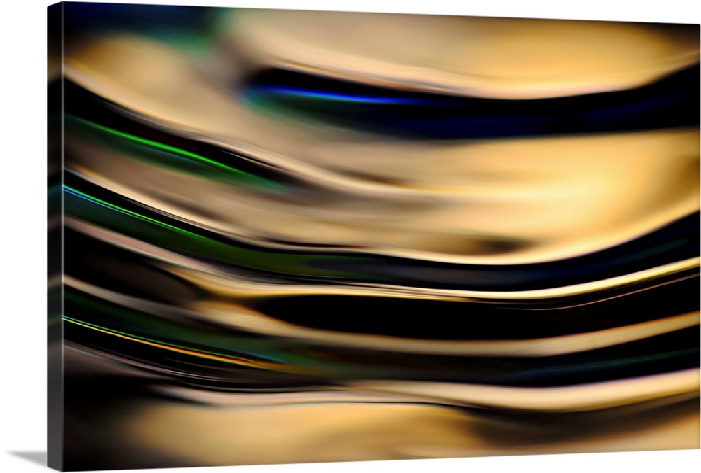 Abstract photograph of rippling water up close with gold reflections and hints of blue, green, and yellow.