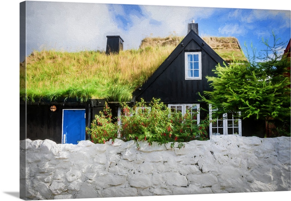 A black house with a blue door with a grassy roof.