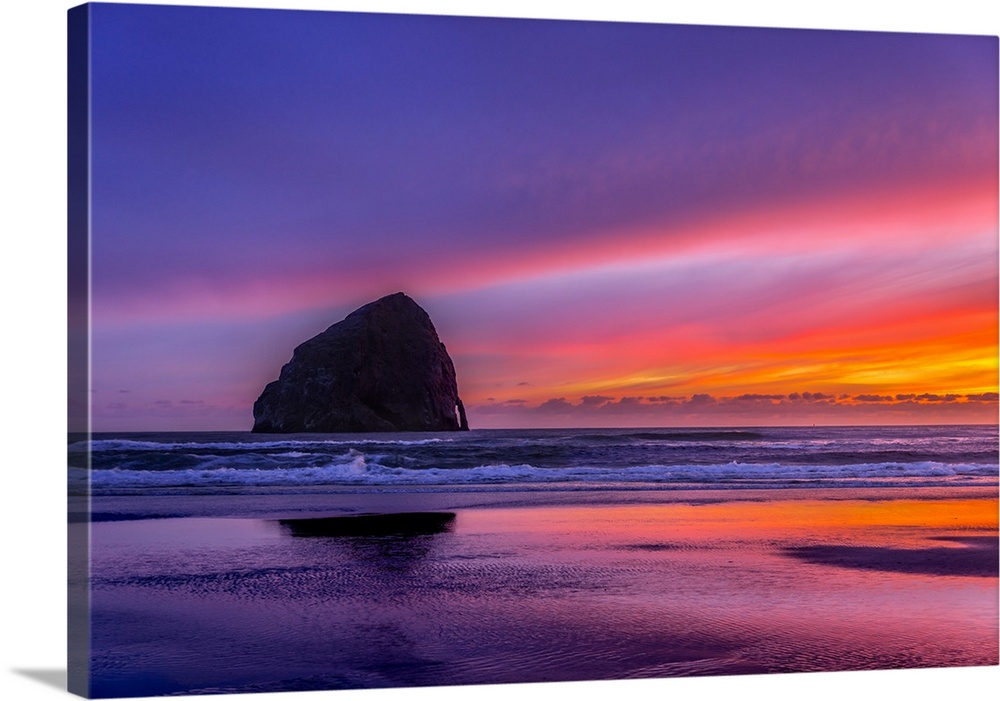 Vibrant purple sunset over Haystack Rock on the Oregon coast.