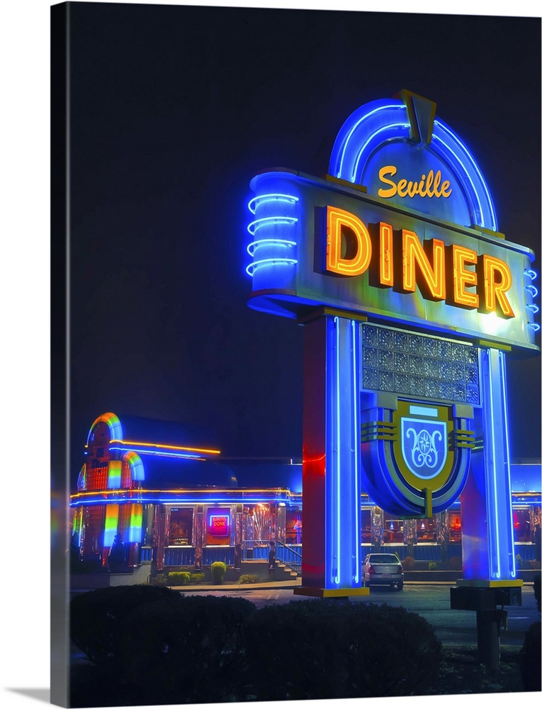 Bright blue neon sign for a diner in New Jersey, illuminated at night.