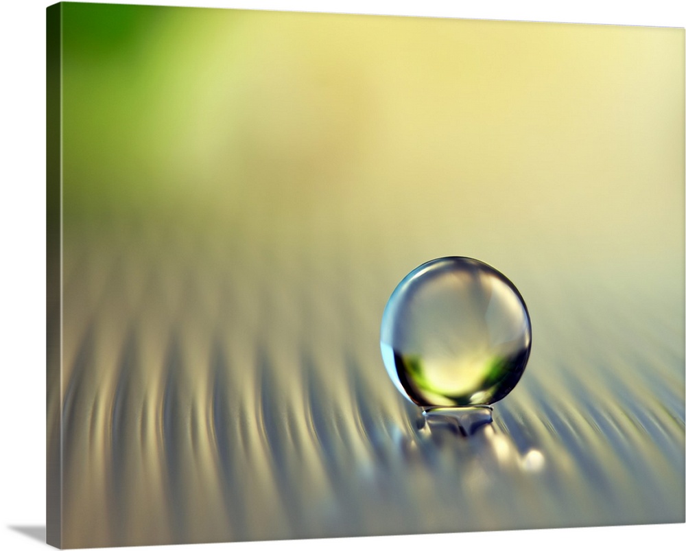 Perfectly round droplet of water on a rippled surface.