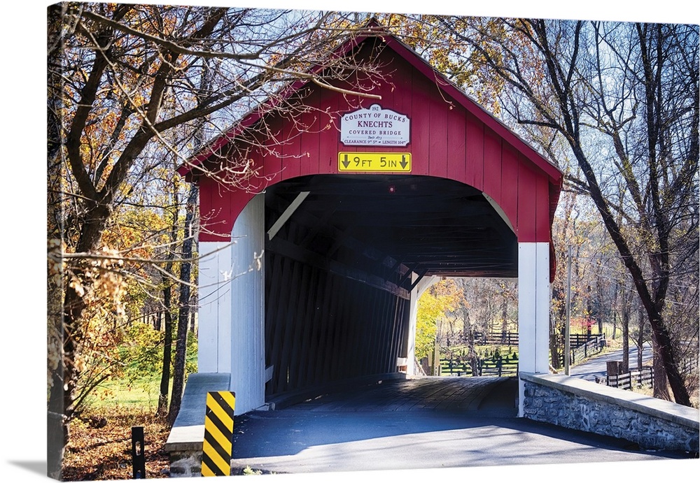View of the Knechts Covered Bridge over the crook creek, during fall. Bucks county, Pennsylvania, USA.