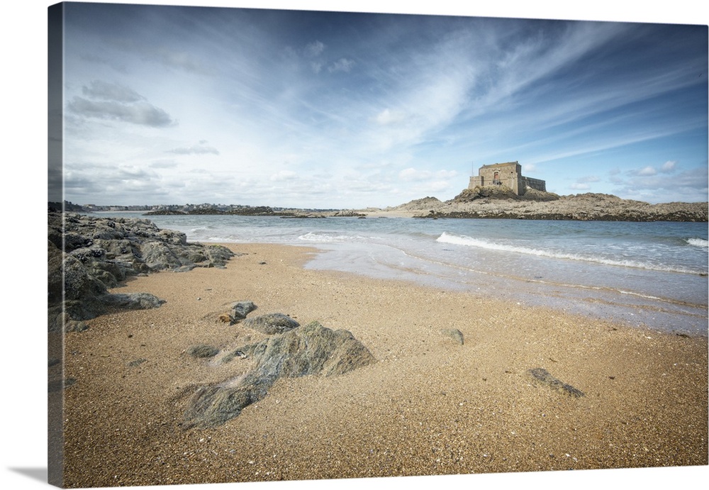 A historic fort on a tidal island, seen from the beach, near Saint Malo, France.