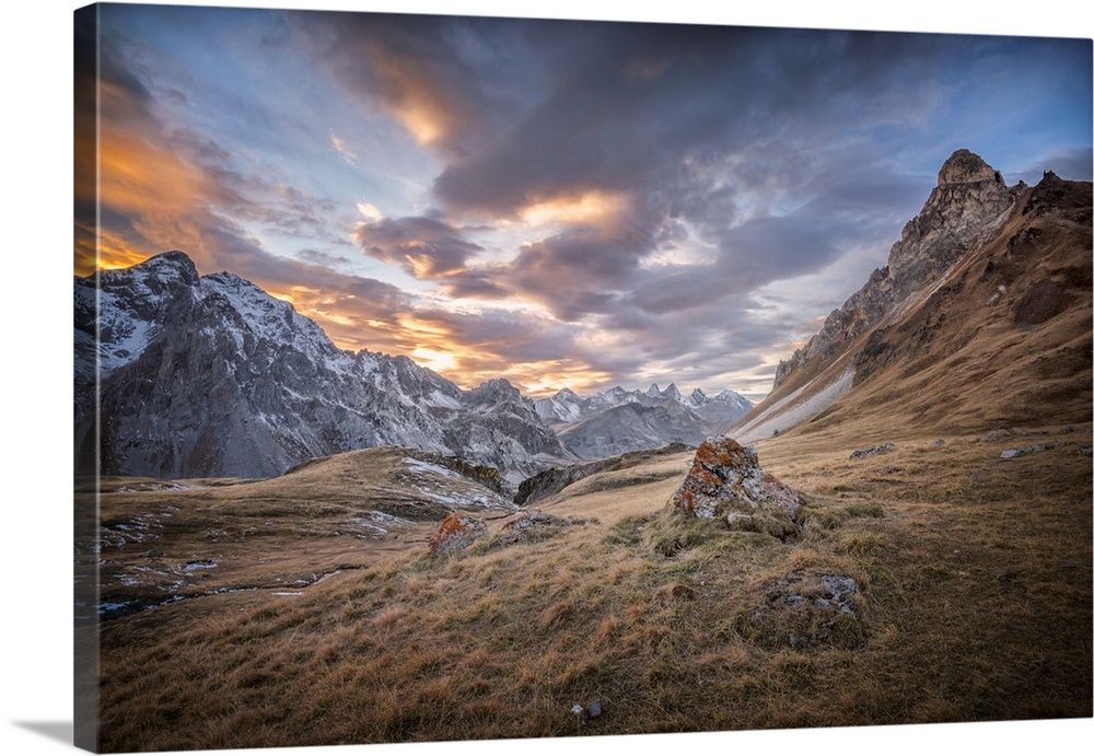 Fine art photograph of an alpine landscape with colorful clouds overhead.