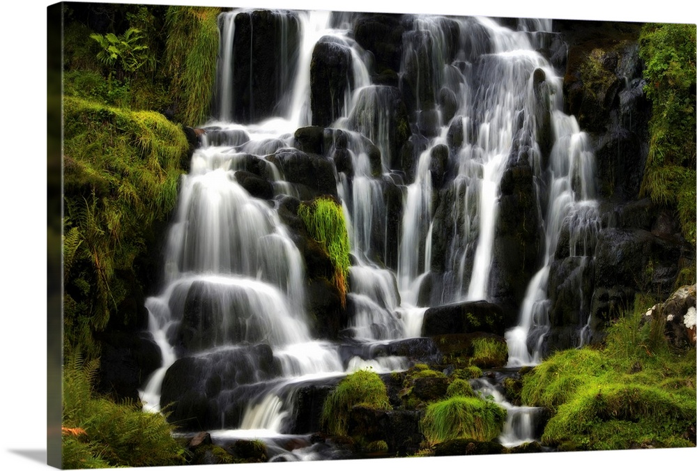 Fine art photo of a waterfall over several round rocks