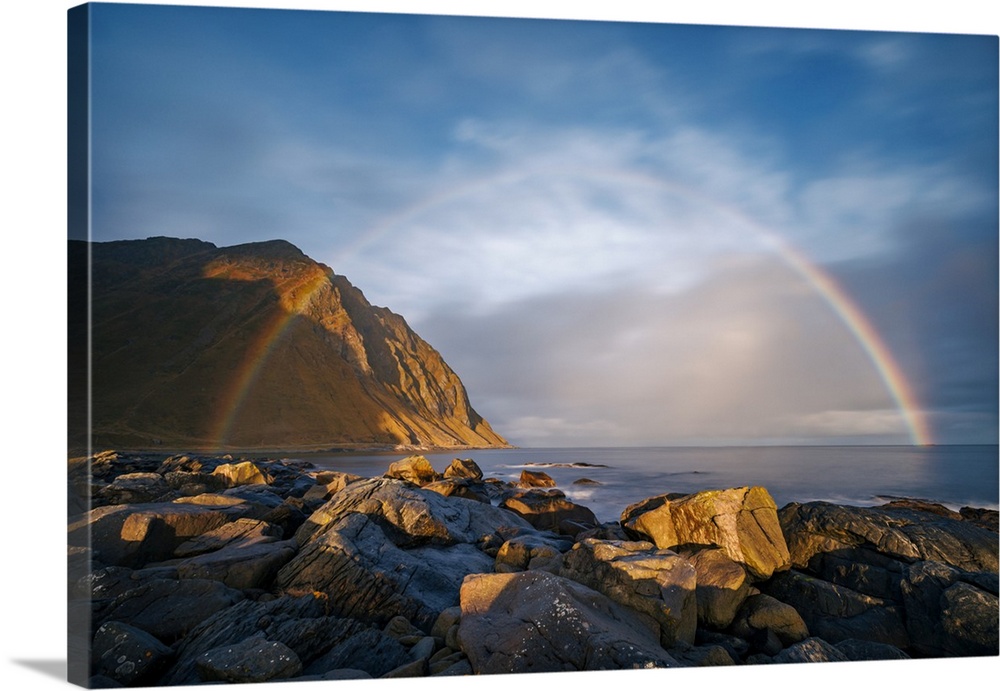 Sunrise at Napp, Lofoten, Norway. Just as I climbed onto the slippery rocks in the morning drizzle, the rainbow grew to it...