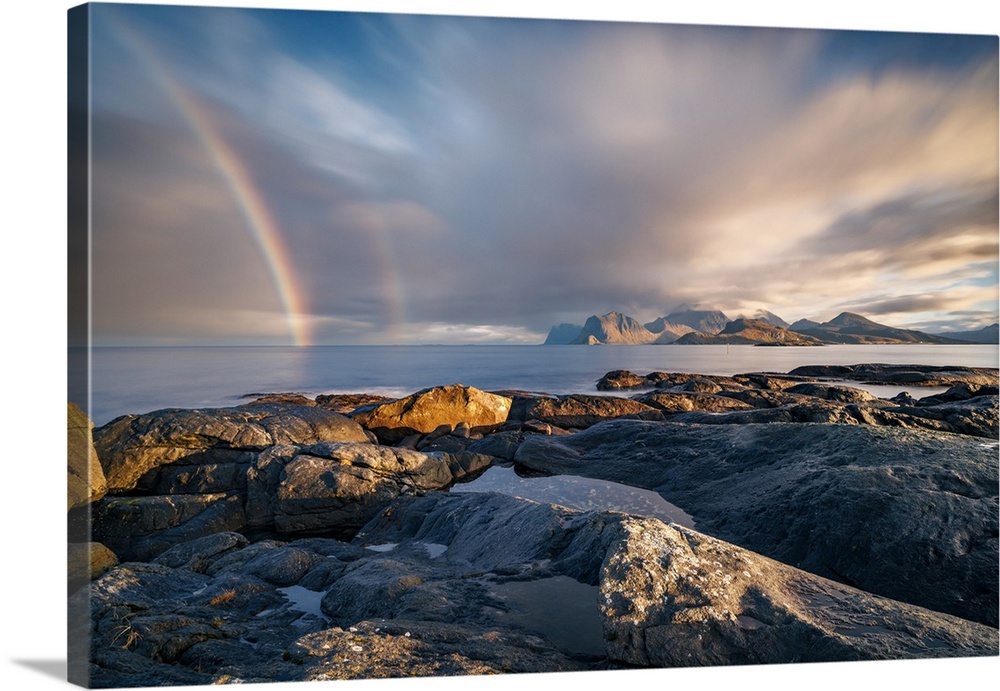 Sunrise rainbow in Lofoten, an archipelago within the Arctic Circle in Norway, known for its scenic landscapes.