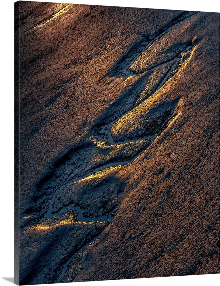 Ridges in the sand formed by receding tide waters at sunset.