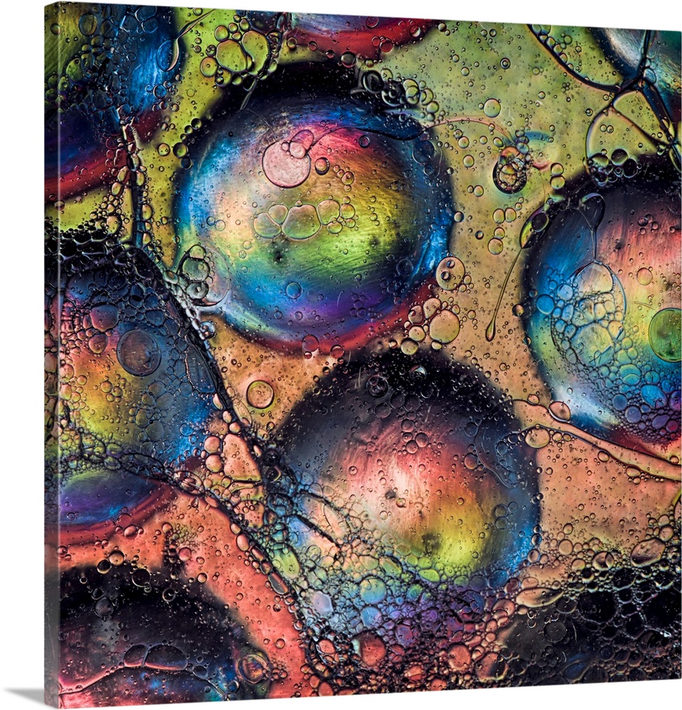 An abstract fine art photo of several bubbles with rainbow colors.