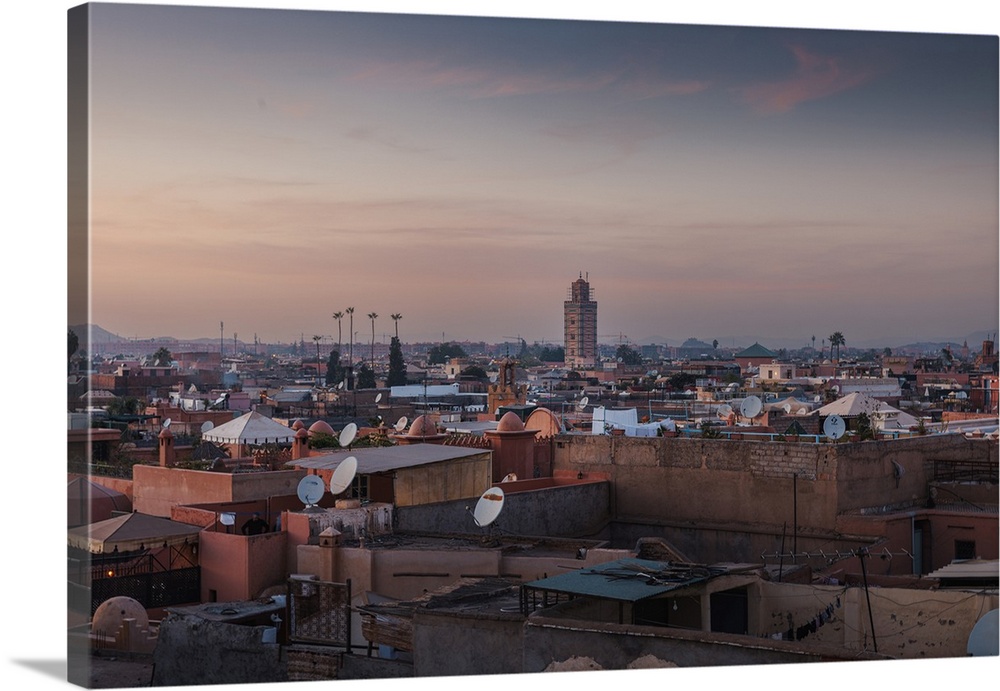 The medina of Marrakesh, Morocco, under pink clouds during sunset.