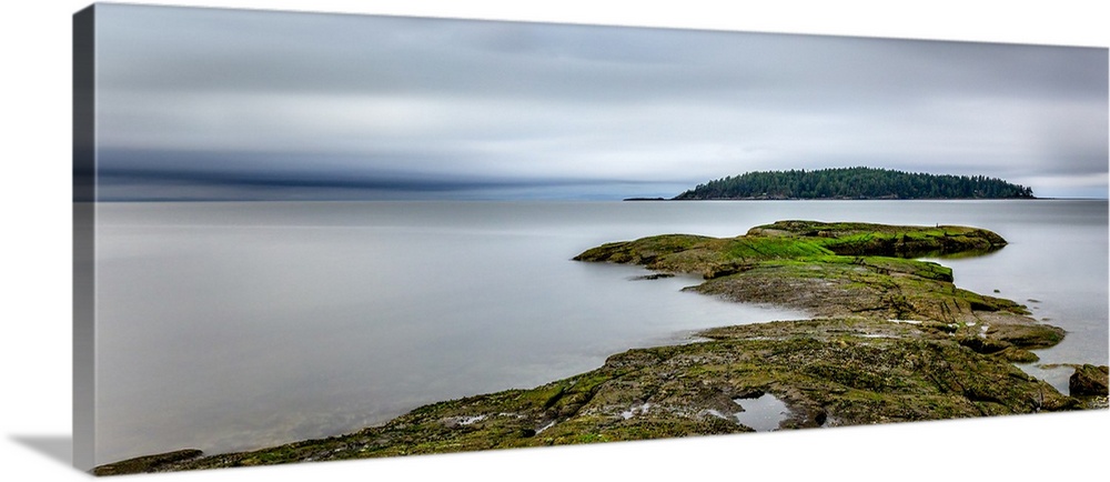 Moody seascape with a piece of land leading your eyes to a distant island, surrounded by soft velvet water.