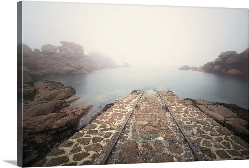 Misty ocean view with rocky outcroppings.