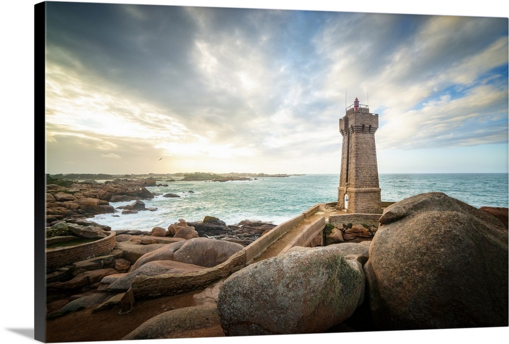 Men Ruz lighthouse in Brittany in France on pink granit coast under a lighthing sky.