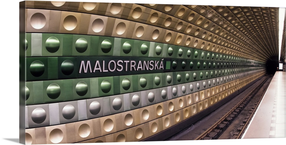 Train tracks at the Malostranska station in Prague, with a geometric pattern in the tiles.