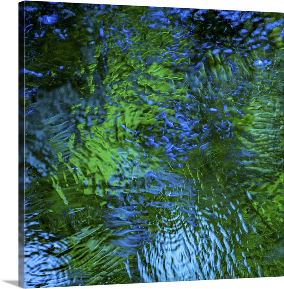Blue and green light reflecting in rippling water.