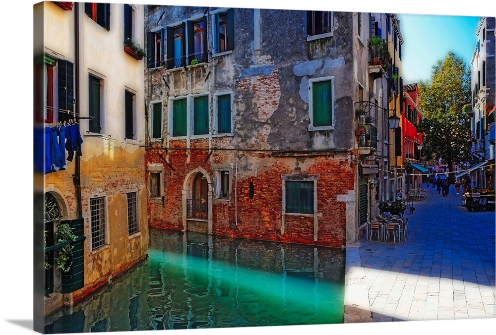 Giant, landscape photograph of tall buildings at the edge of a canal in Calle Del Spezier, Venice, Italy.  The canal leads...