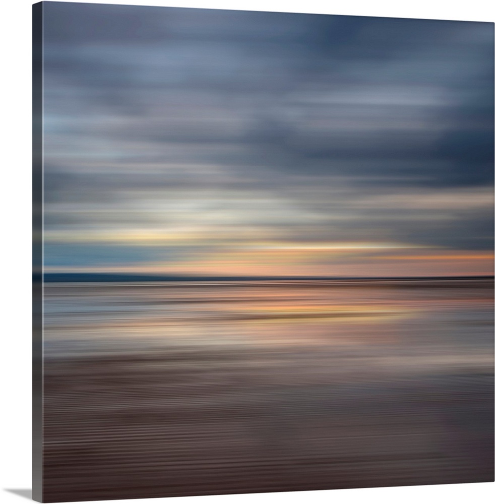 Oversized fine art photograph of sunset on a horizon in horizontal streaks of warm and cool tones.