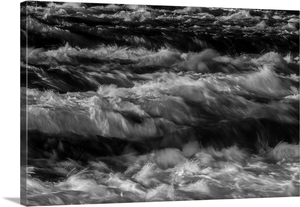 Black and white photograph of water rapids created with a long exposure.