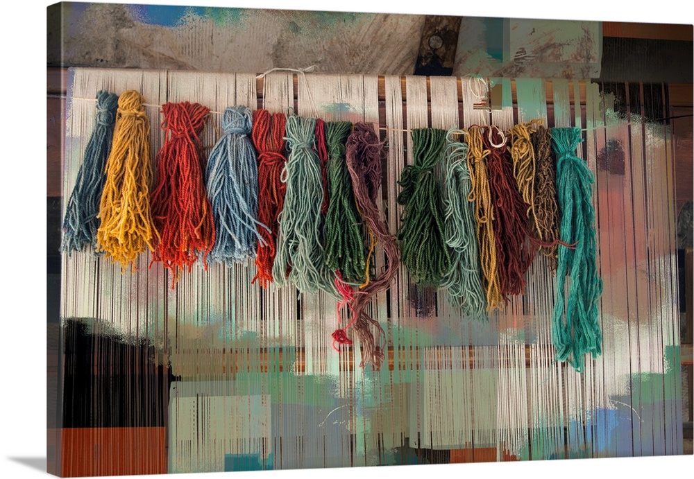 Photograph of colorful bundles of yarn hanging on a line with an abstract background.