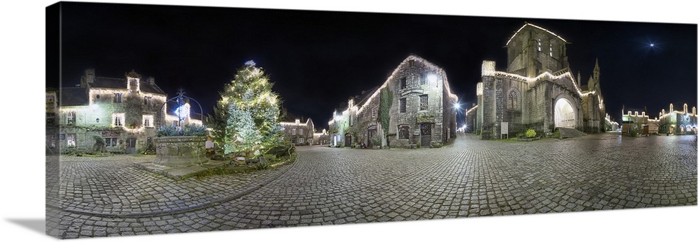 Panoramic view of a historic village at night.