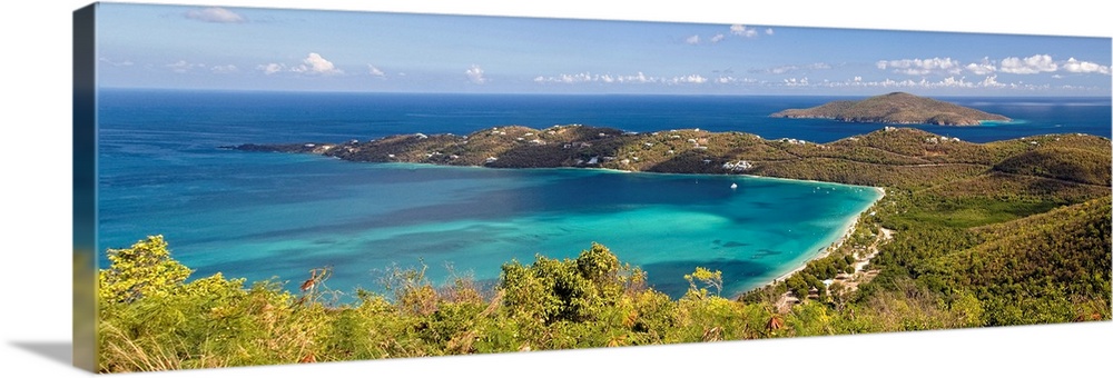 This panoramic photograph is an aerial shot of a bay in the virgin islands surrounded by large hills.