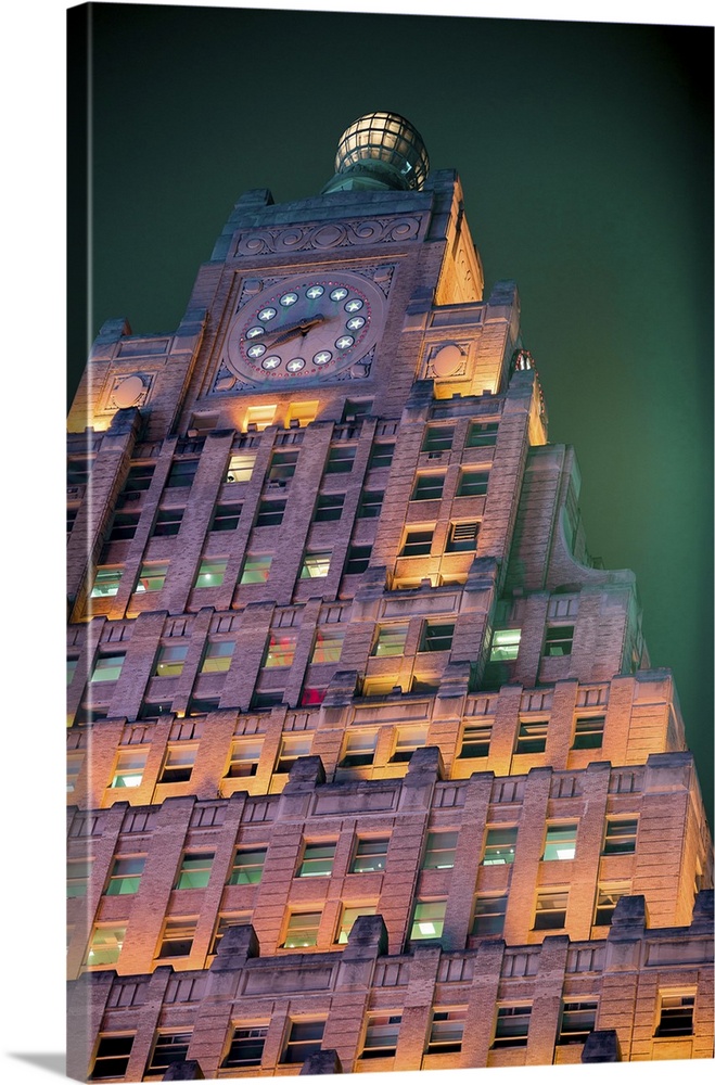 Deeply atmospheric view of New York City's Paramount Building at night, with a lit facade and engulfed in fog glowing lumi...