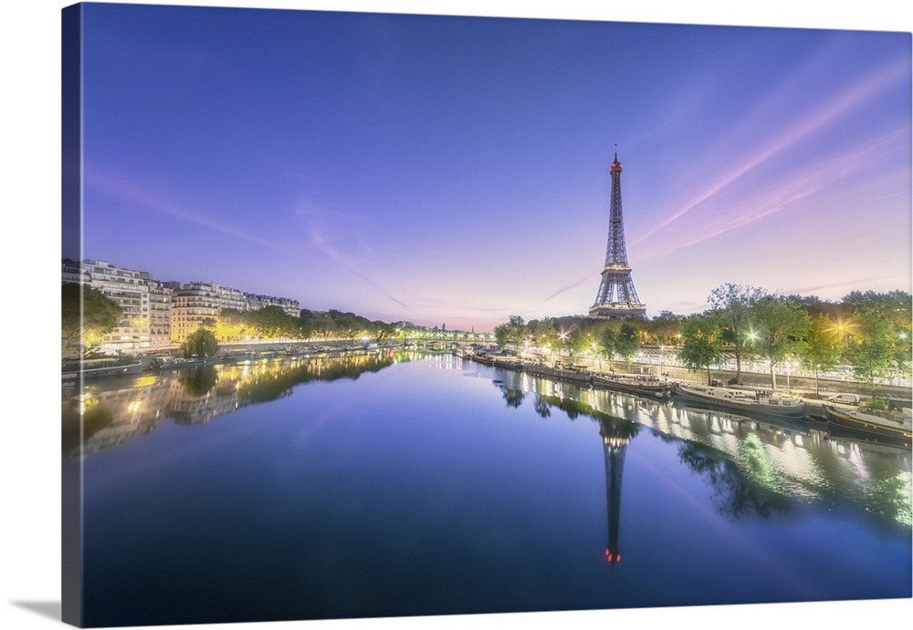 Sunrise on a summer morning in Paris, view of the Seine with Eiffel tower, boats, buildings and Lena Bridge.