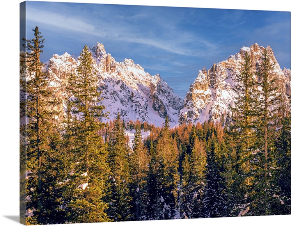 Photo shot in the Dolomite mountains, the snow-capped peaks behind the Alpine fir trees. I used a 50mm lens at ISO 200.