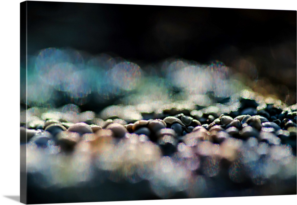 A photo of pebbles that have been blurred in the foreground and background.