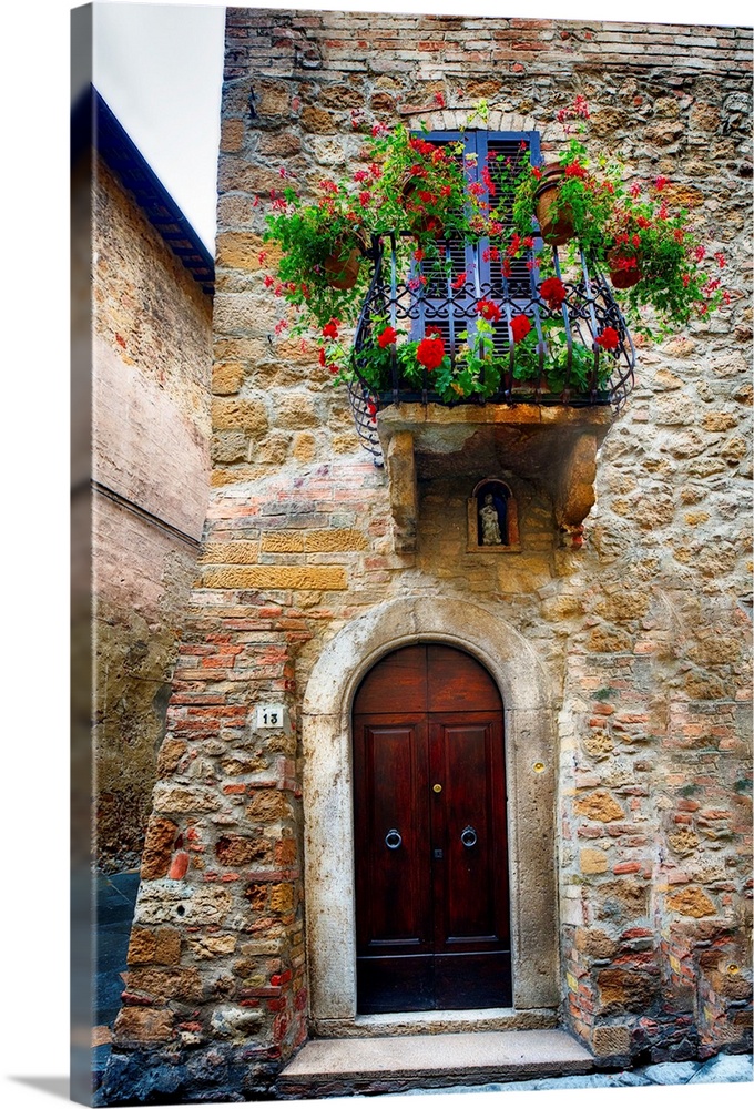 A photograph of the outside of a door and balcony in Italy.