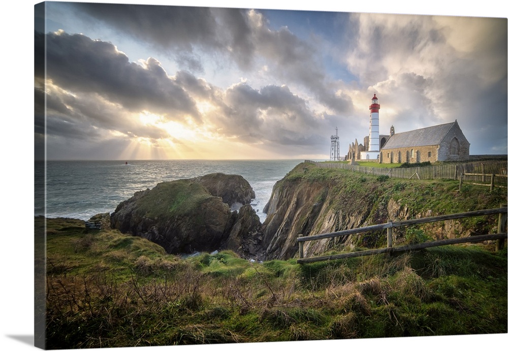 Landscape view of Brittany shoreline called pointe saint mathieu at sunset with rays of light in the clouds. The most famo...