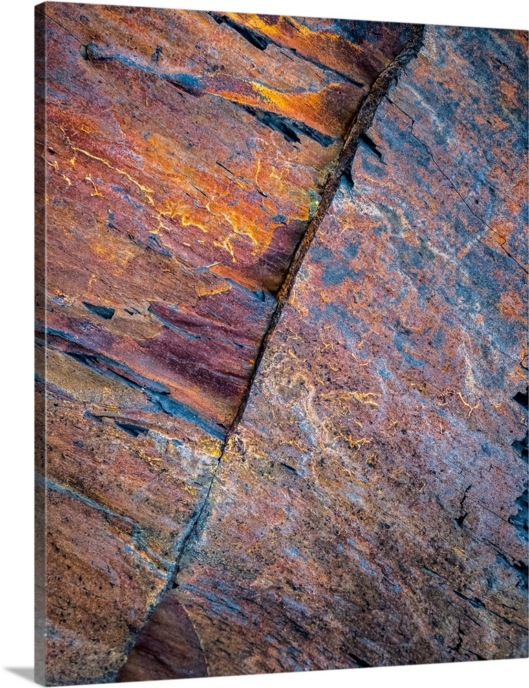 A contemporary natural abstract of patterns in rock in rich pinks, oranges, blues, golds and purples.