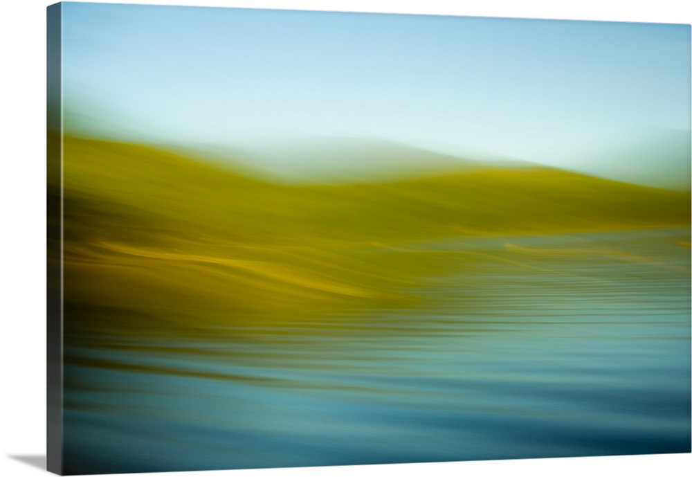 An abstract ocean scene of the water rhythmically flowing onto the gold beach.