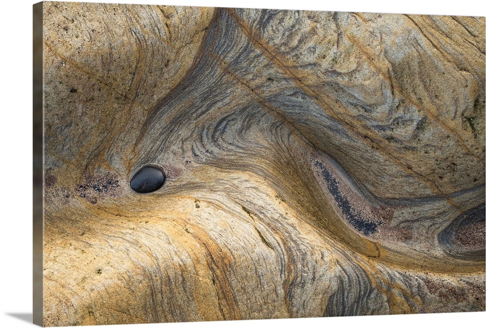 Abstract photograph of a rocky surface displaying all its layers of age and experience.