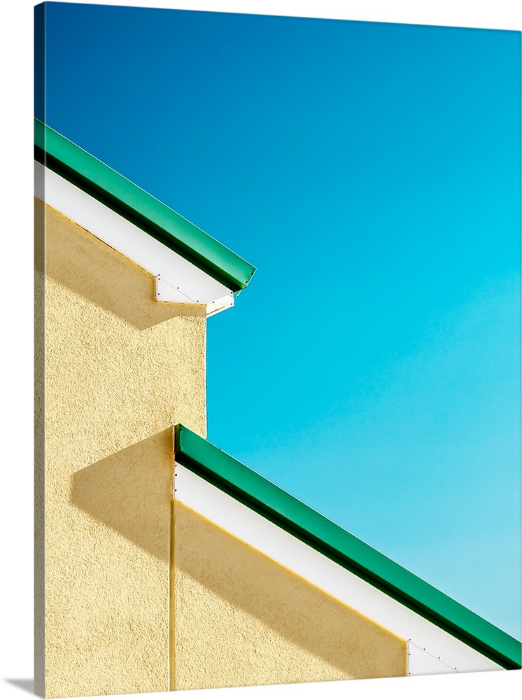 Abstract view of the green roof of a house against a blue sky.