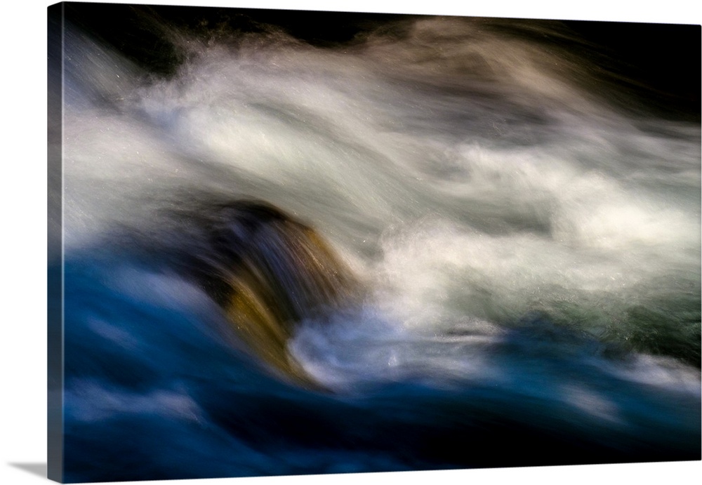 A photo of rushing water with foam that has been edited to a smooth effect.