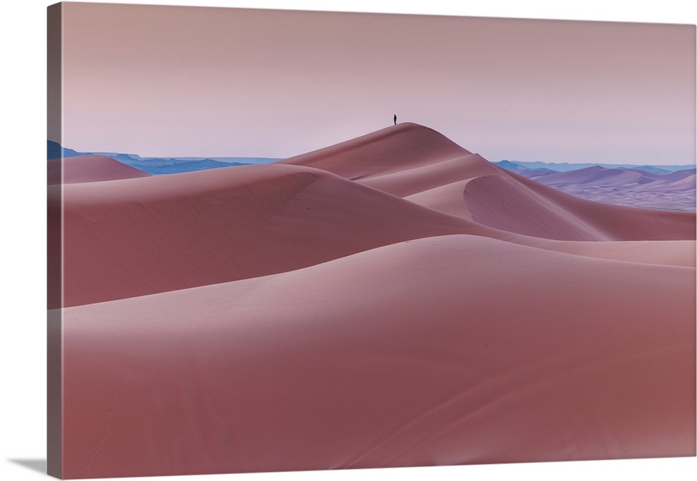 Peaceful moment in layers of sand dunes at Sahara Desert in Morocco before sunrise.