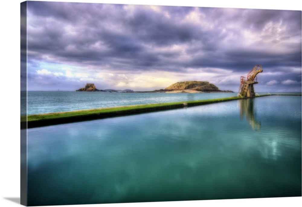 Saint Malo in Brittany, France, the natural sea water pool called Piscine de Bon Secours, with clouds and sea.